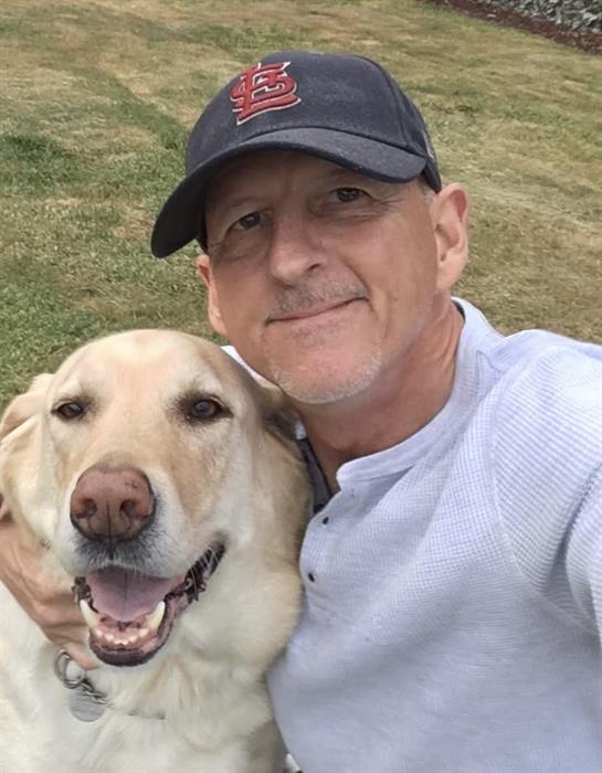 A man taking a selfie with a dog