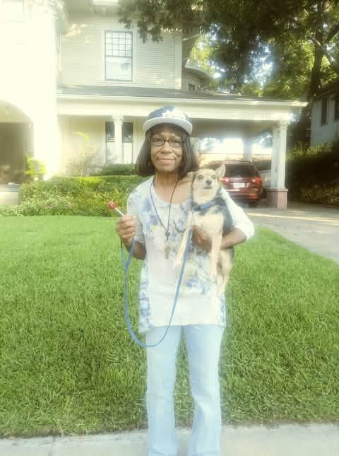 A woman holding a dog in her arms