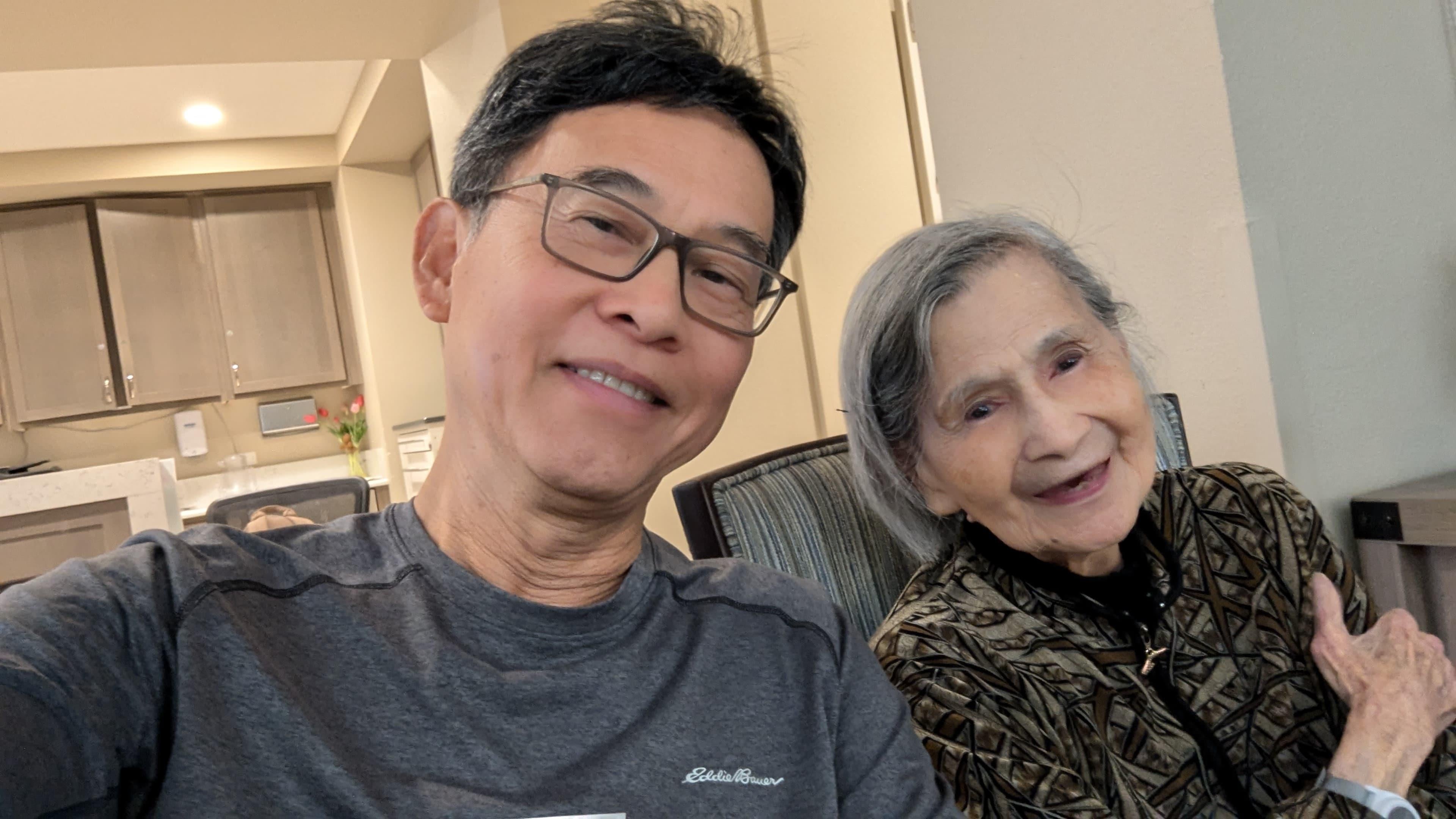 Two family members enjoy a warm moment together in a comfortable indoor environment.