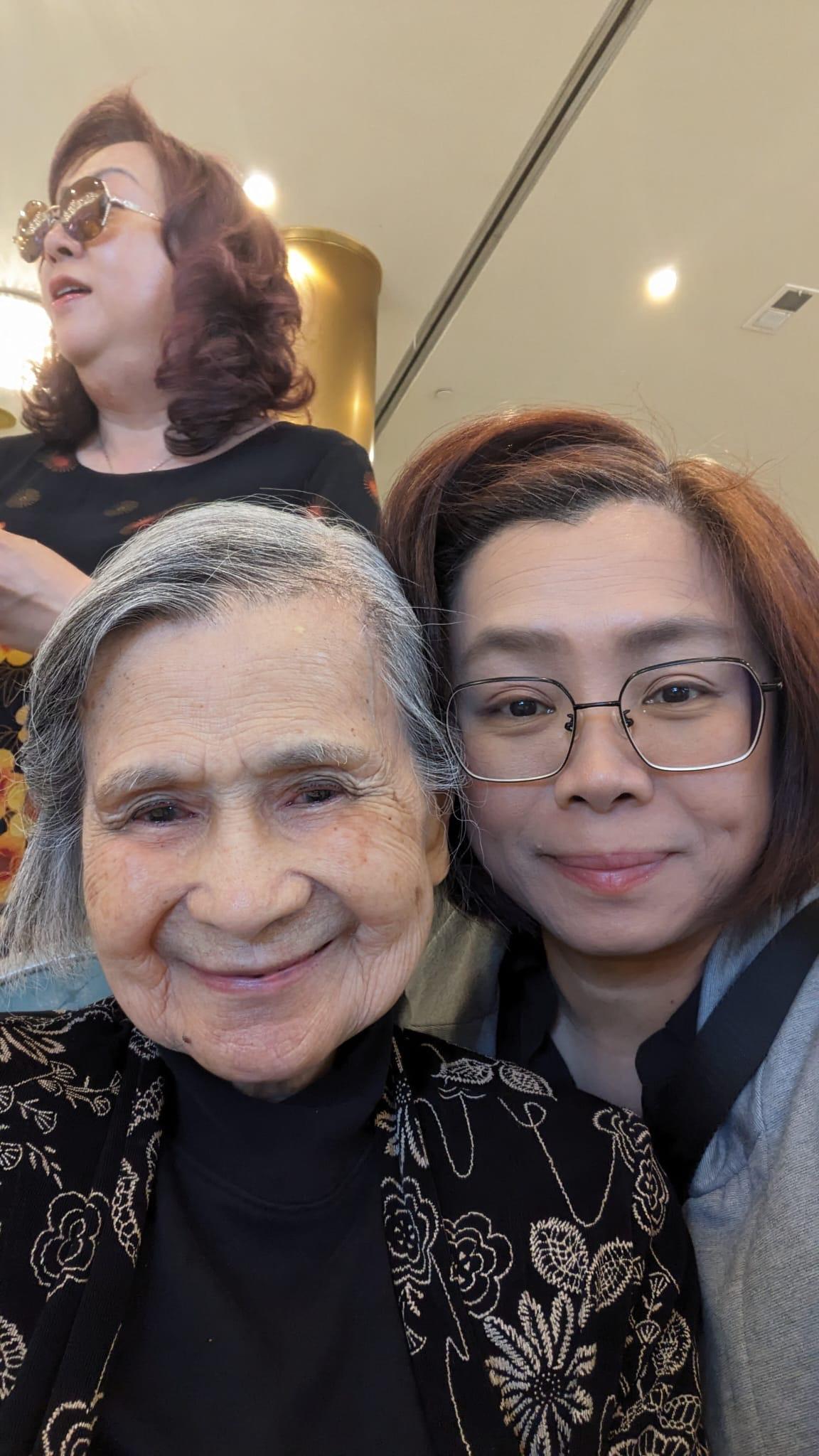 Two generations share smiles and warmth during a special family gathering indoors.