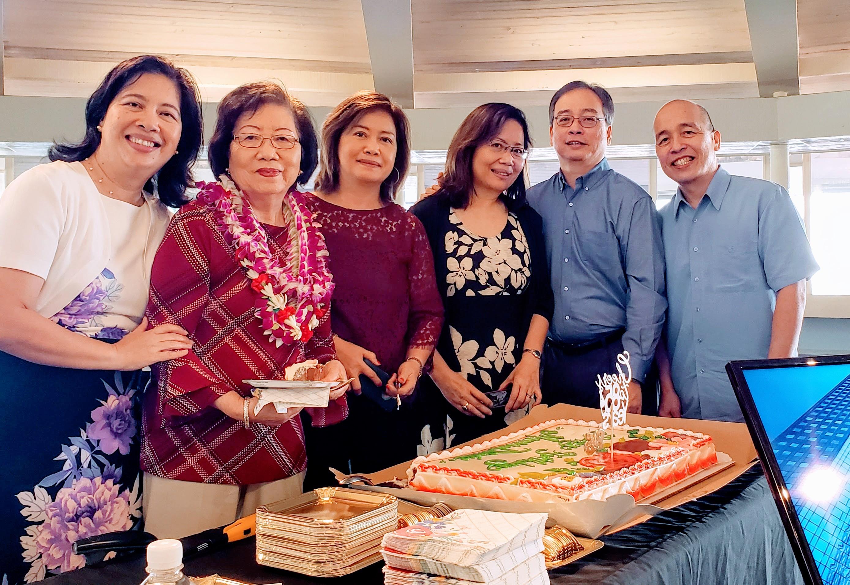 Friends and family enjoy a festive gathering, sharing cake and laughter in a cozy setting.