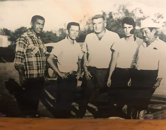 A group of men posing for a photo