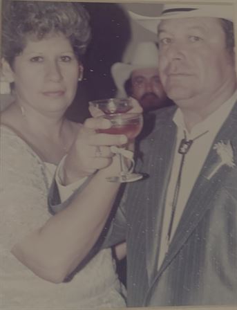 A man and woman holding wine glasses