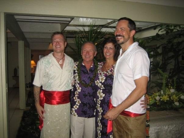 Four friends in traditional attire celebrate a festive atmosphere and embrace culture.