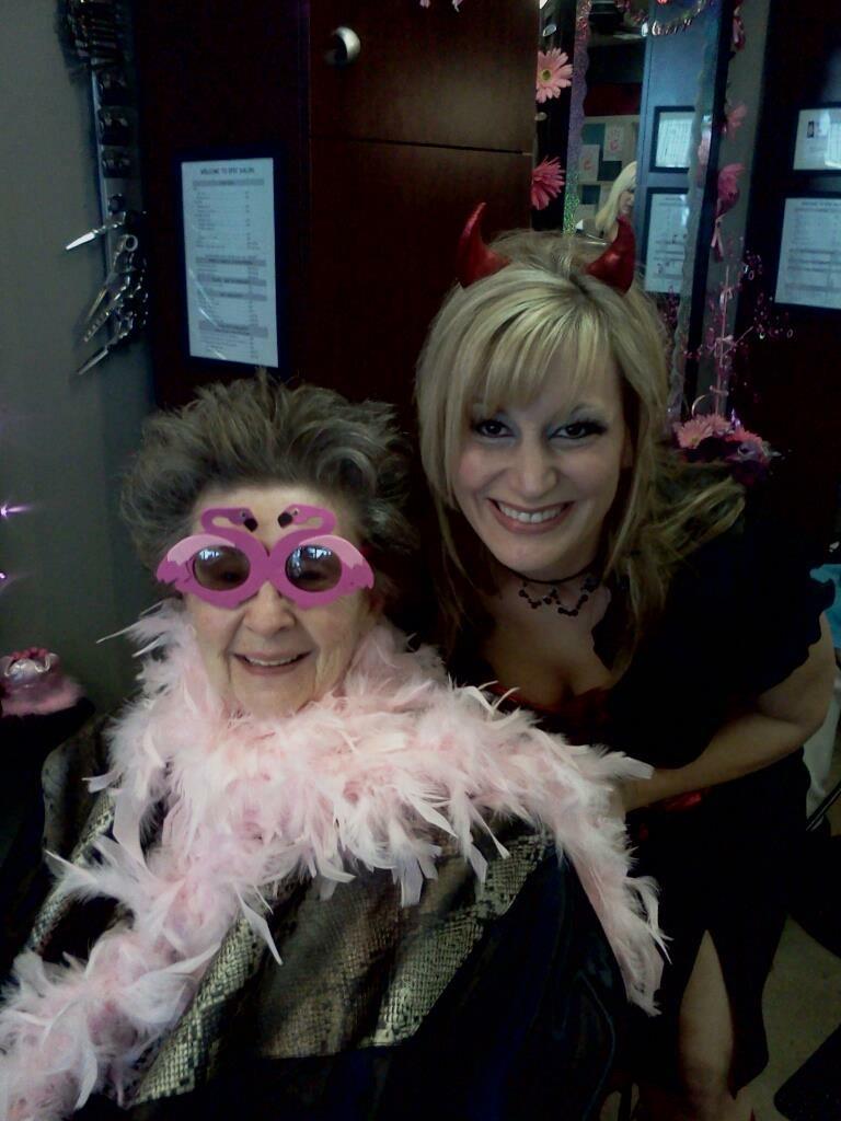 Two women revel in a lively costume party, flaunting vibrant outfits and fun accessories.