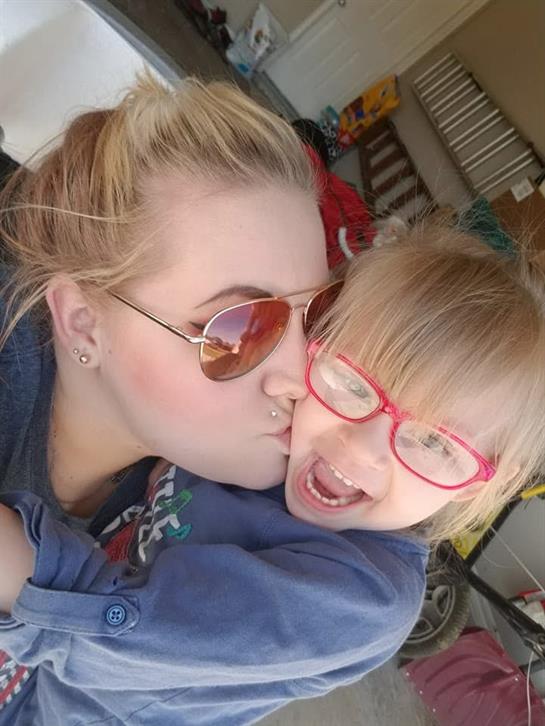 A woman kissing a child