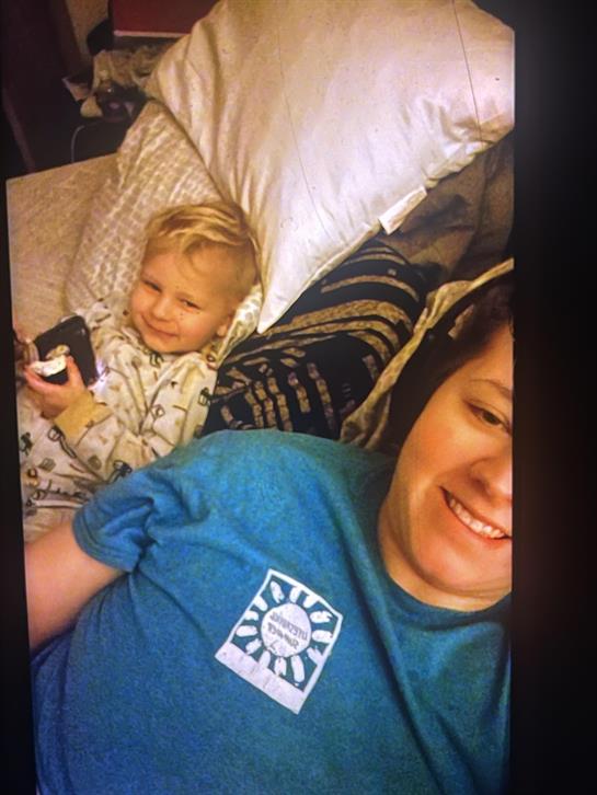 A man and child lying on a bed