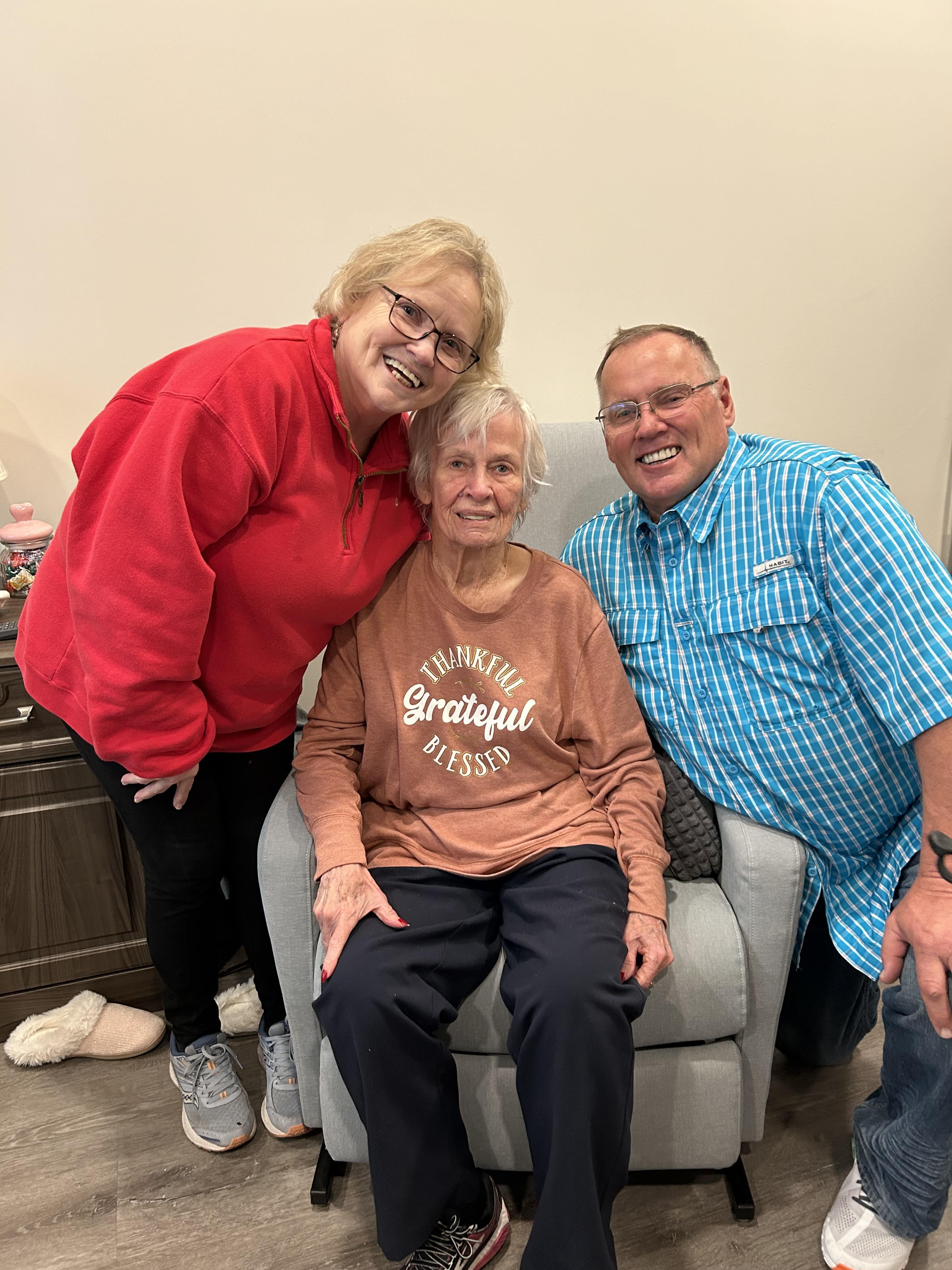 Family members enjoy a heartfelt visit, smiling and sharing memories in a cozy environment.