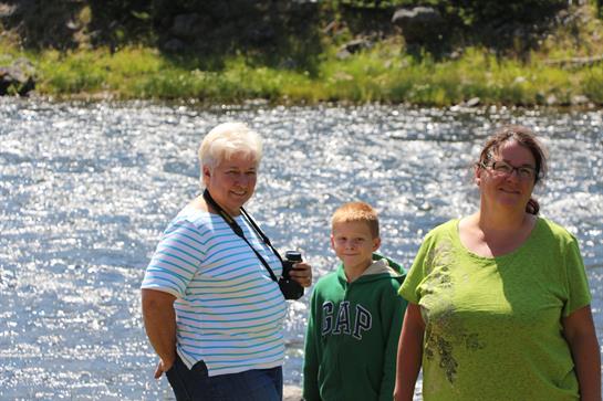 A group of people standing by a river