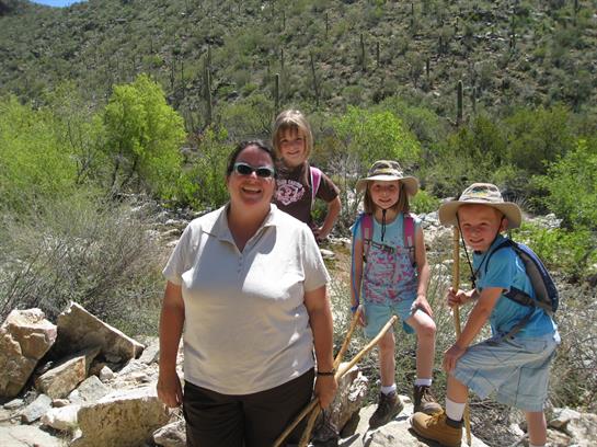 A woman and kids posing for a picture