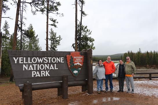 A group of people standing in front of a sign