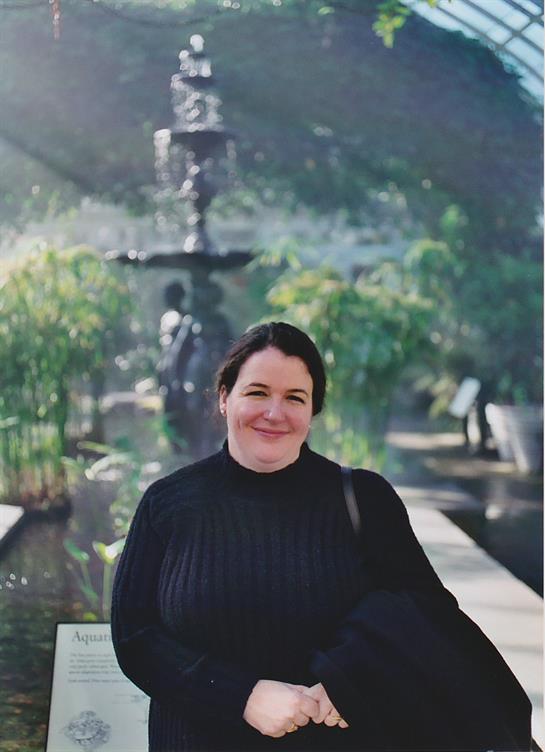 A woman sitting in front of a fountain
