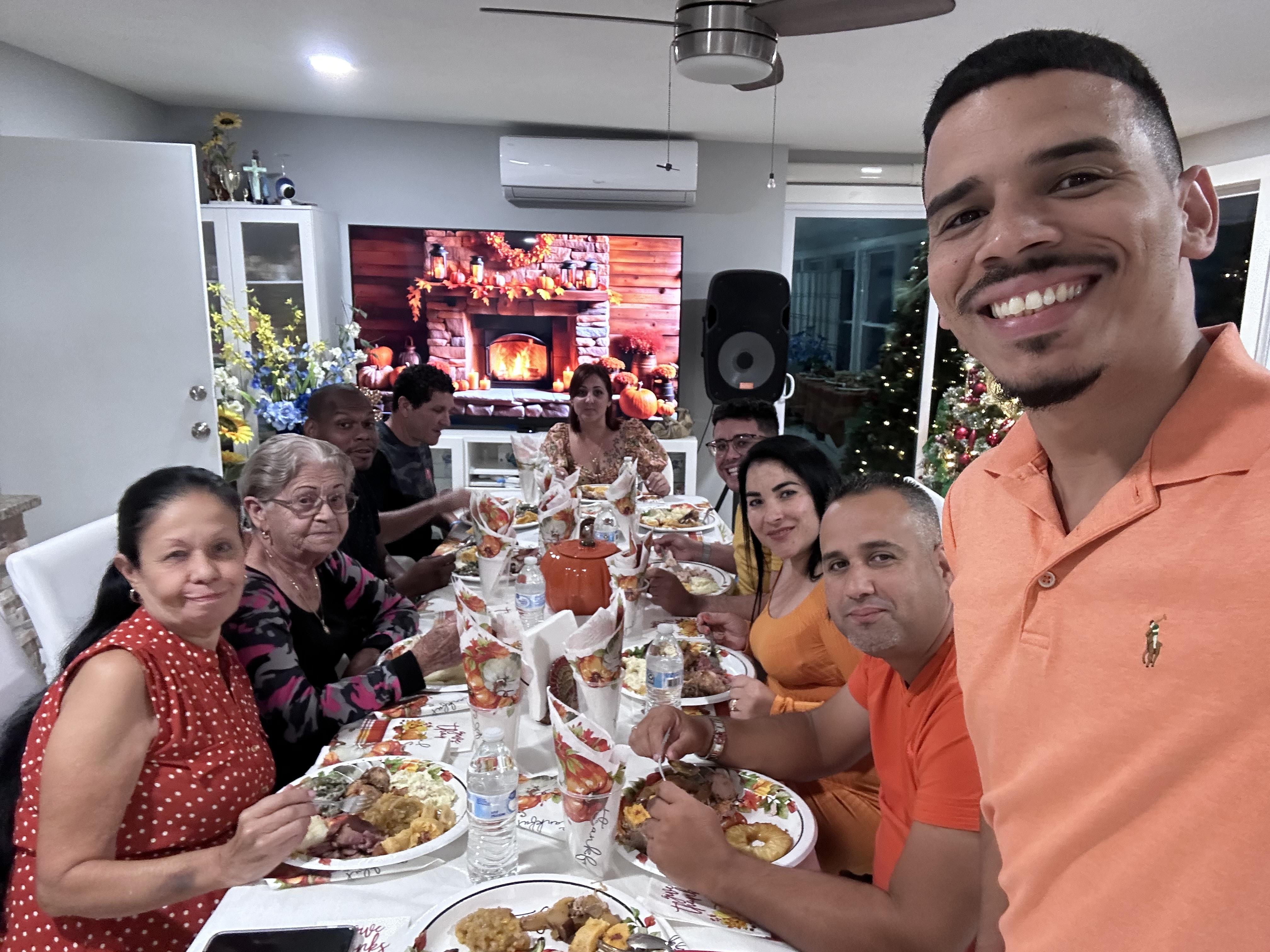 Friends and family gather for a joyful dinner celebration with a warm atmosphere and festive decor.