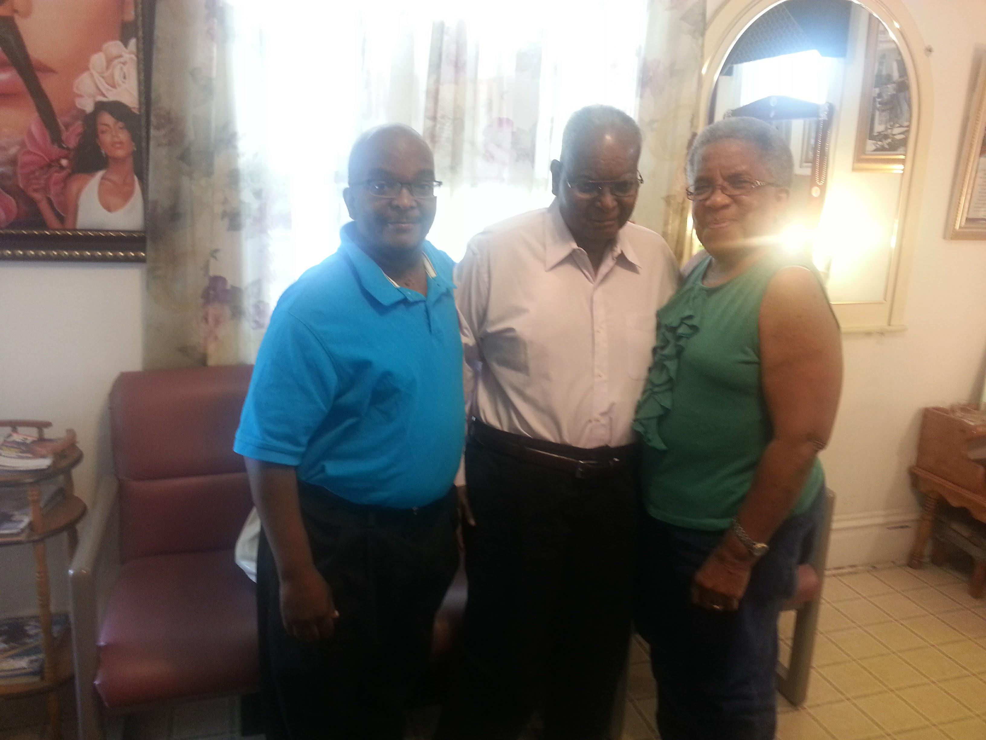 Friends stand together in a cozy living room, exchanging stories and laughter in good company.