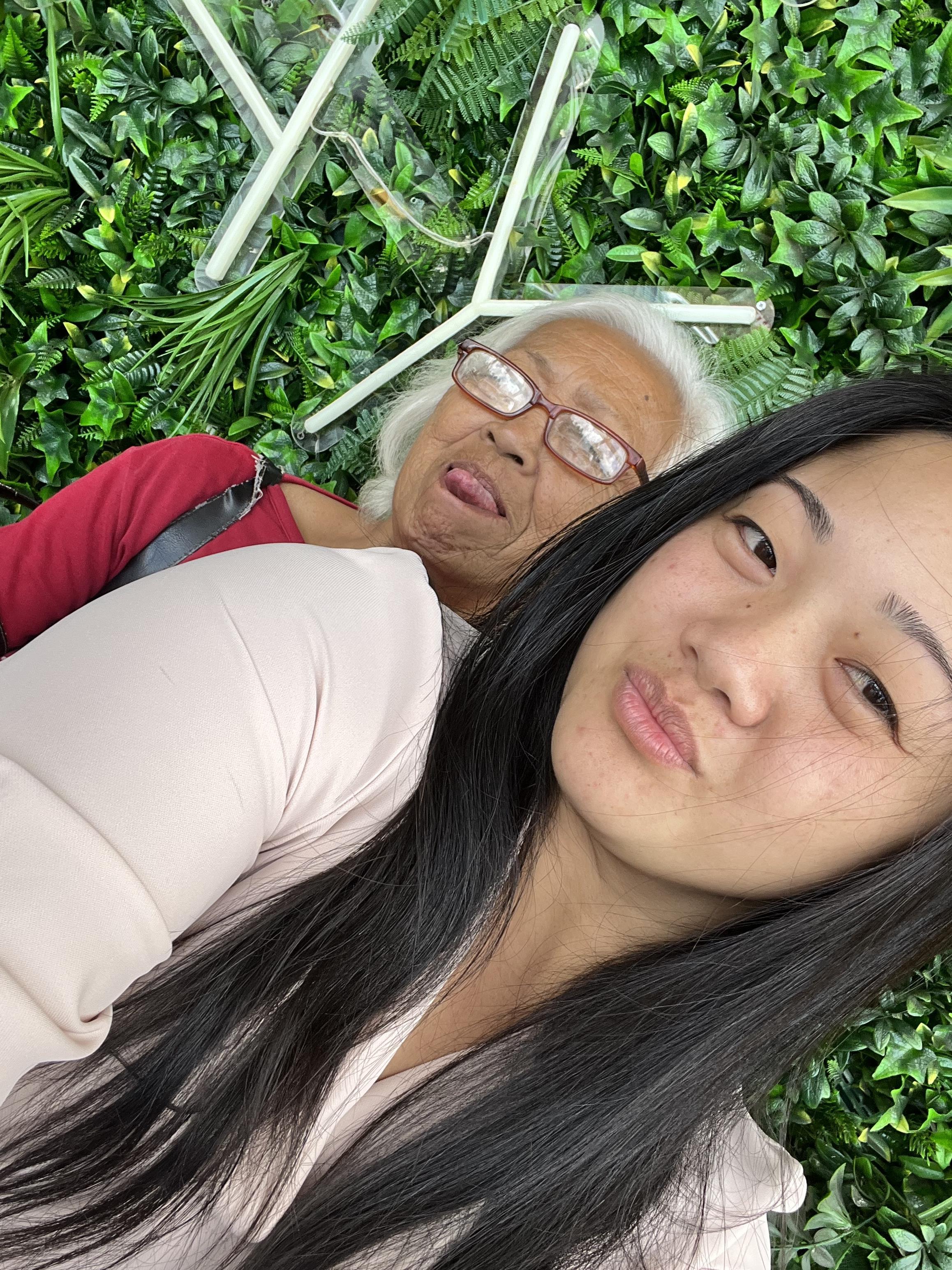 A woman taking a selfie with an older woman