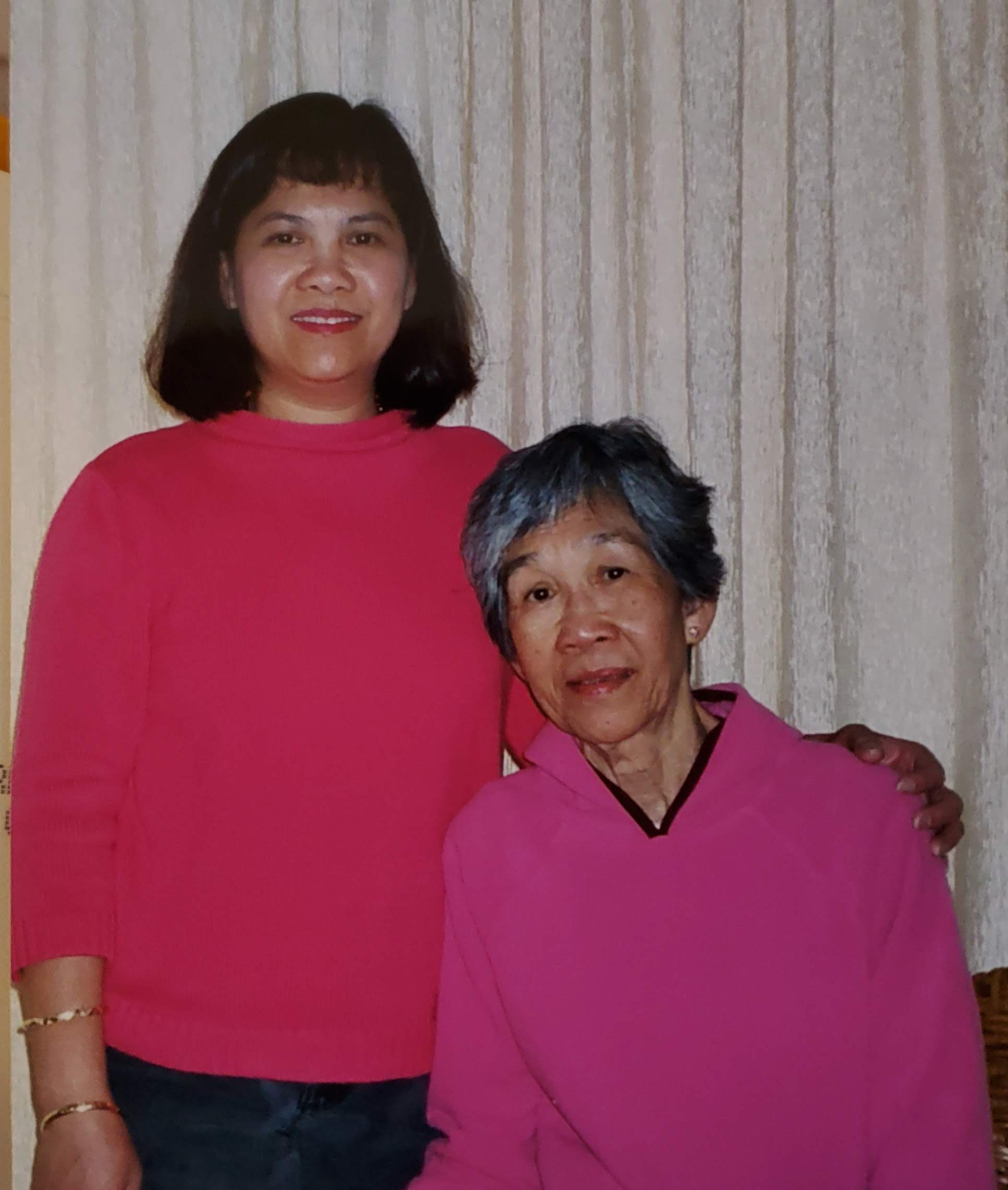 A woman and a woman posing for a picture