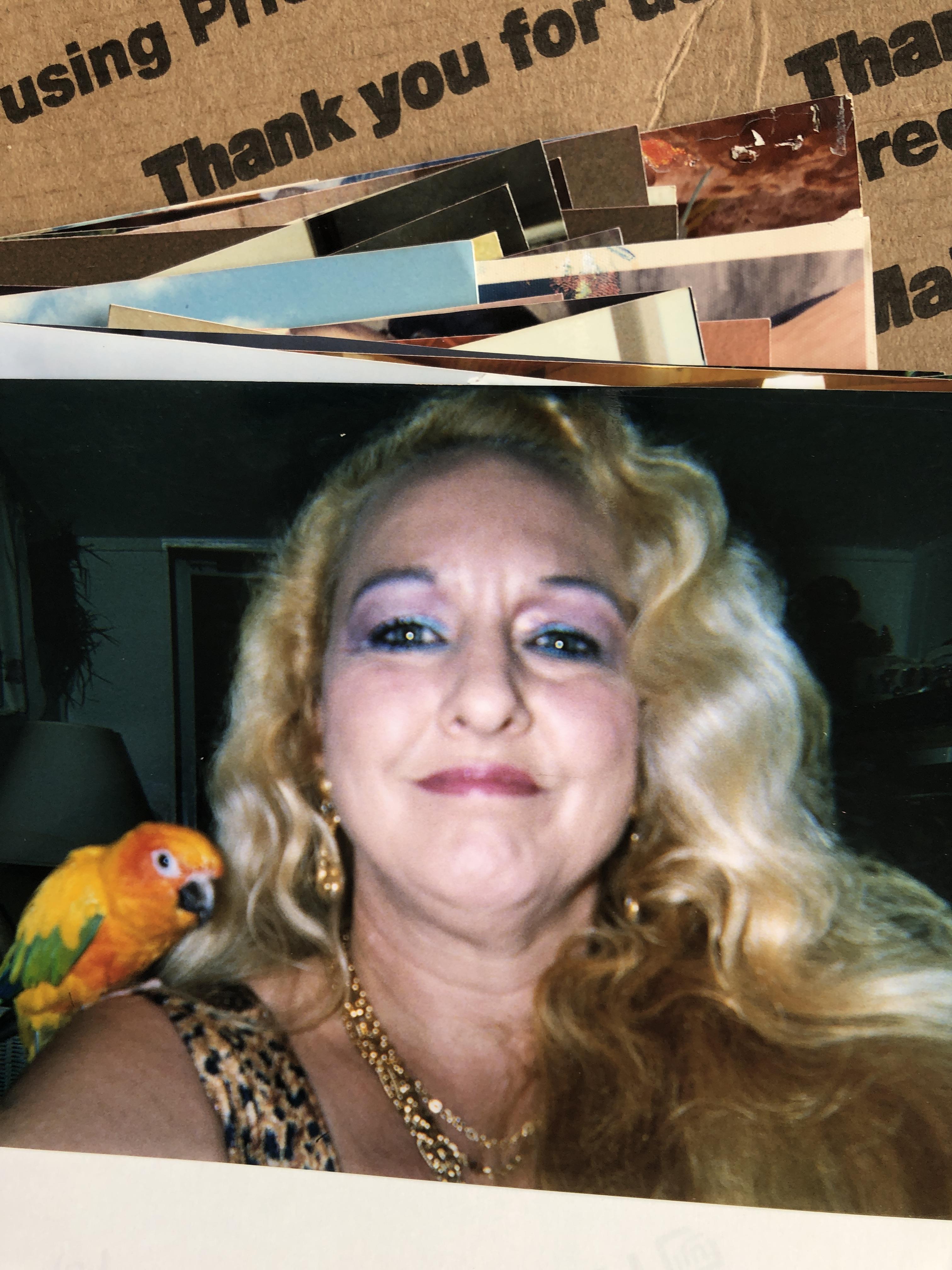 A woman with a parrot on her shoulder