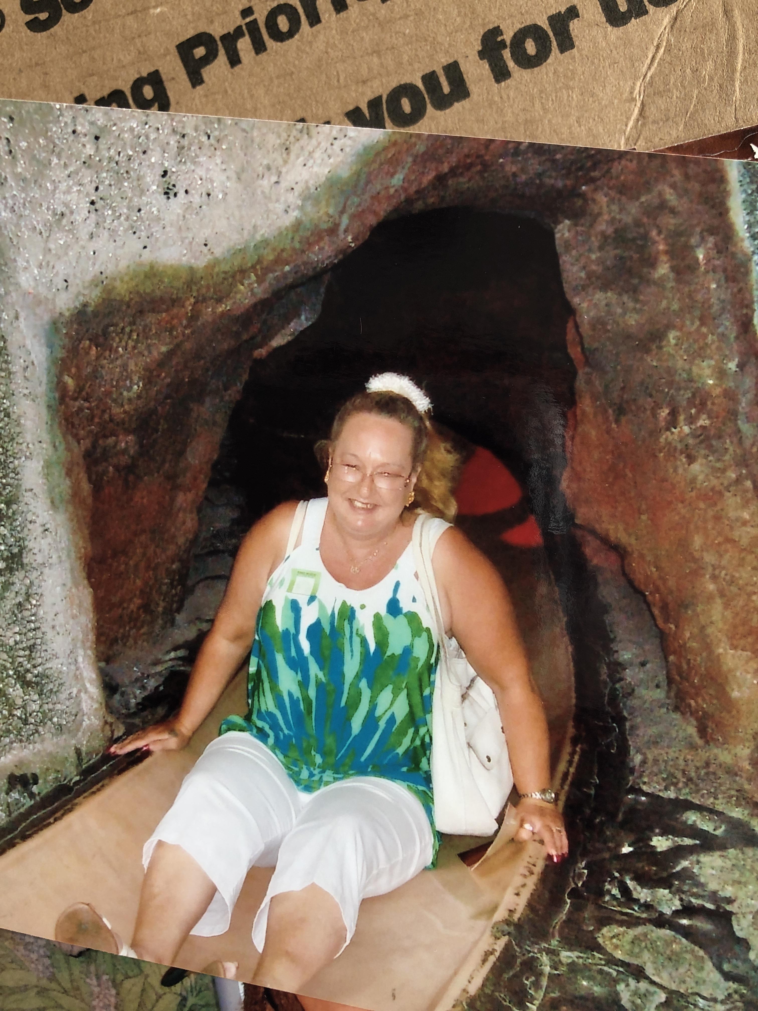 A woman sitting in a cave