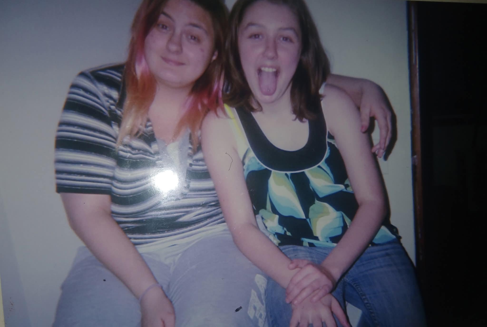 Friends share laughter and fun while posing playfully for a casual snapshot indoors.