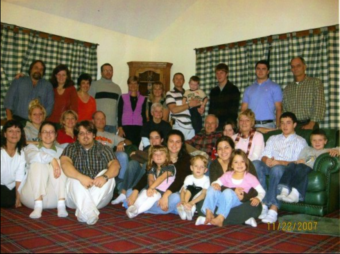 A big family smiles together in the living room, cherishing moments and making memories.