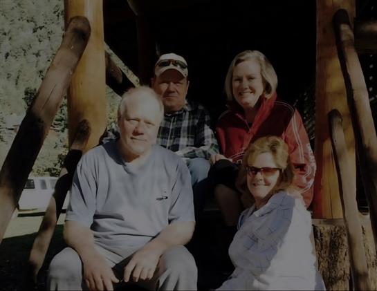 A group of people sitting on a porch
