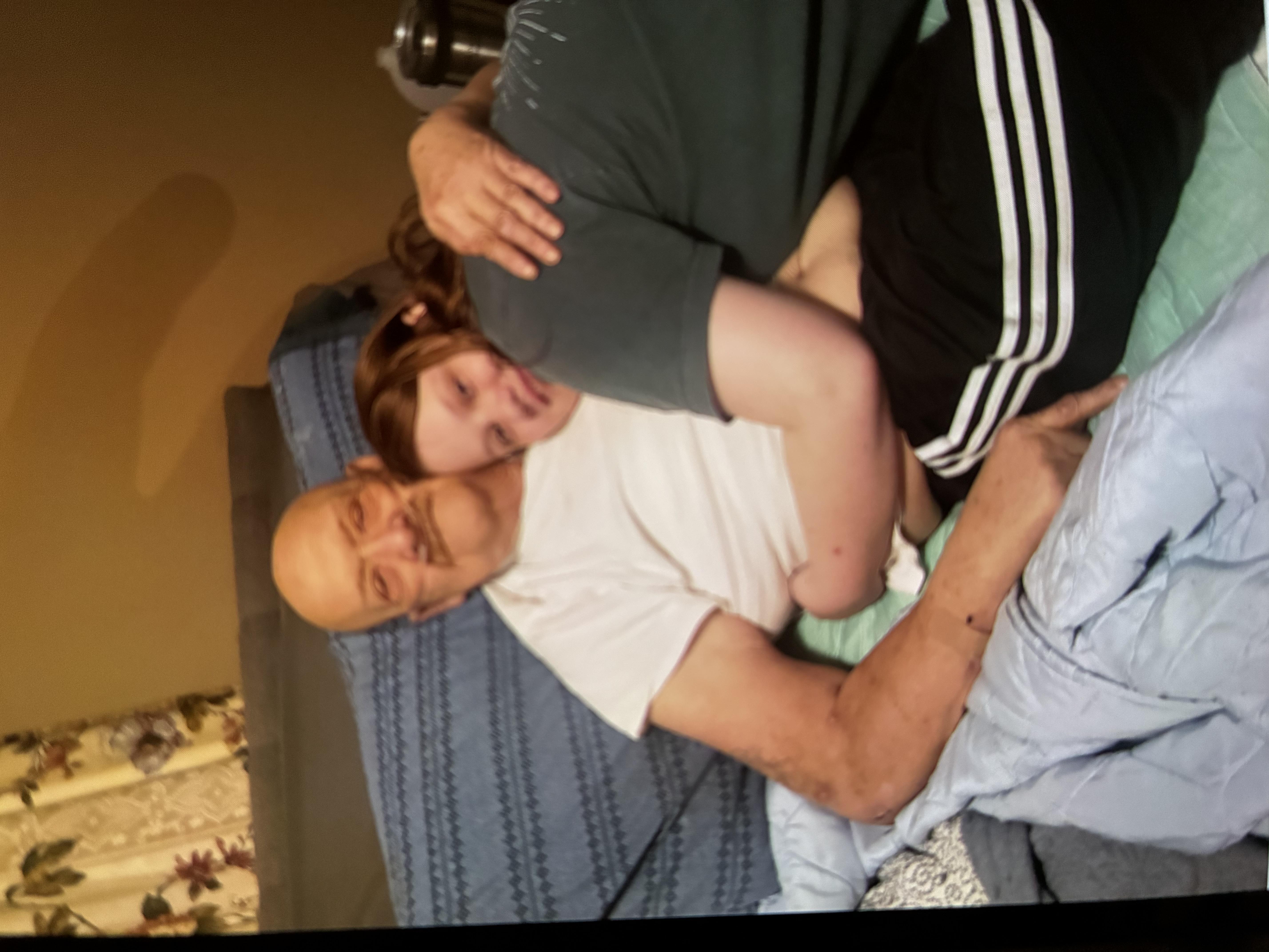 A man and woman lying on a bed