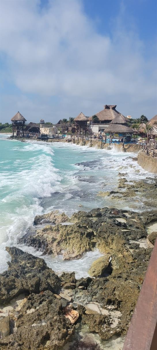A beach with a body of water and buildings