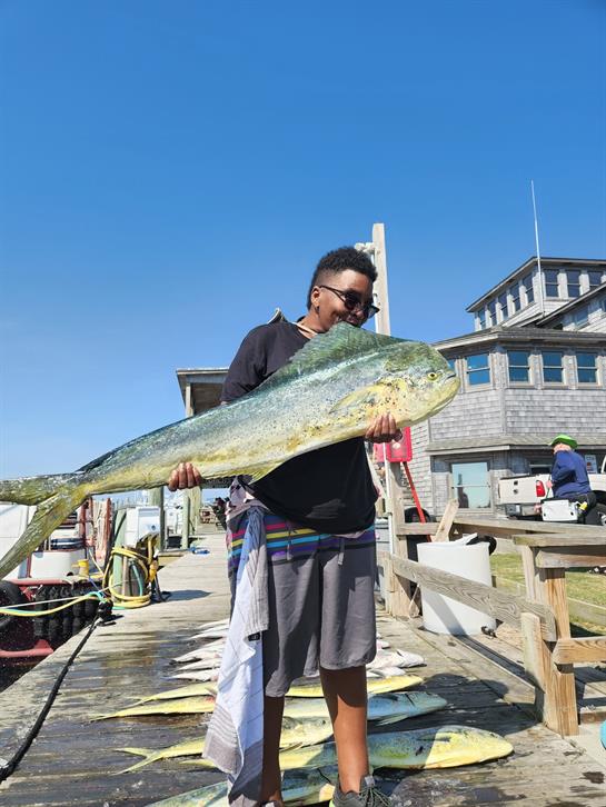 A woman holding a large fish