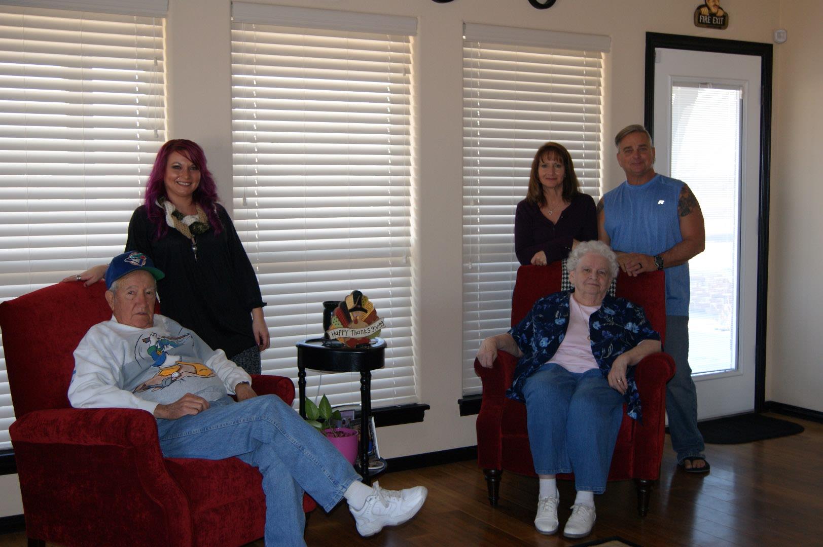 A family comes together in a welcoming living room with elderly relatives seated comfortably.