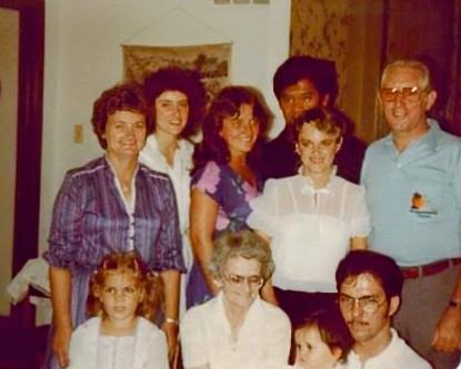 A group of family members poses together, showcasing smiles and close relationships from the 1970s.