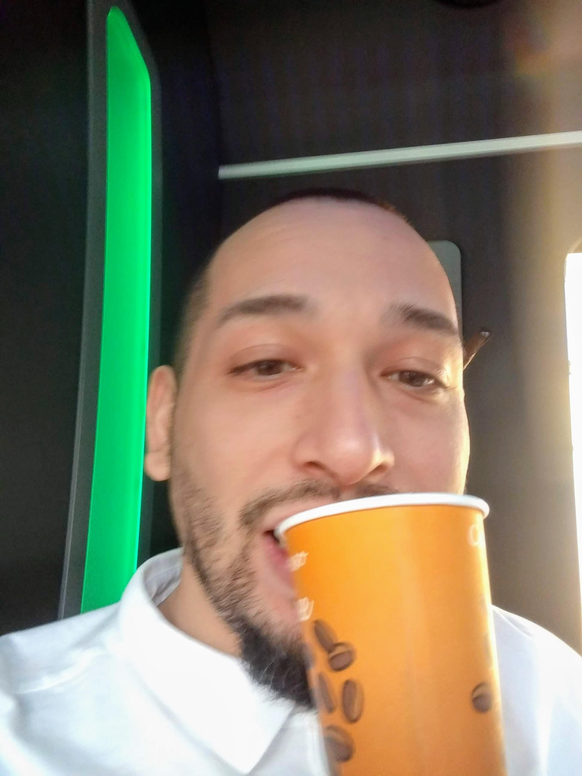 A man drinking from a cup