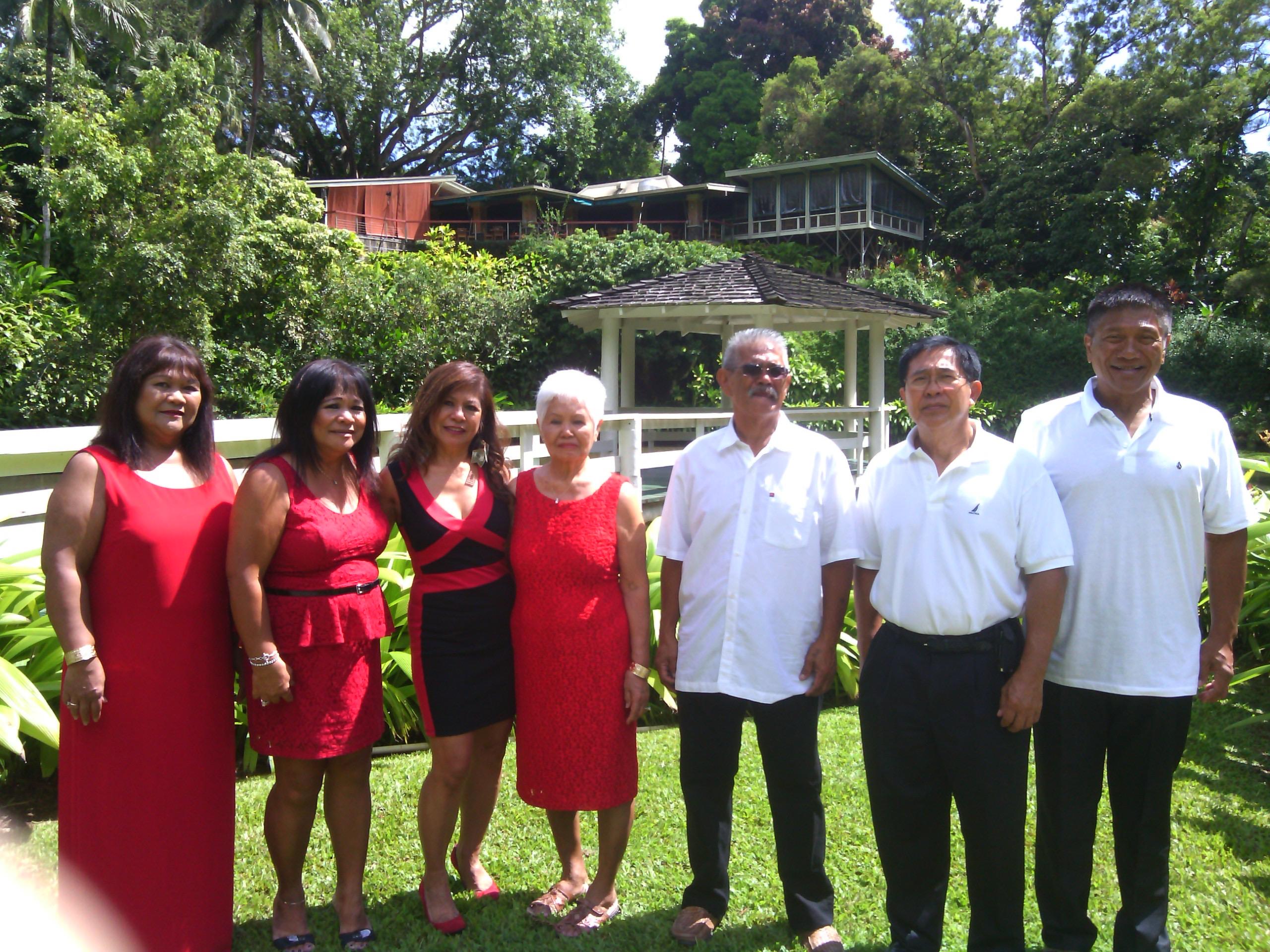 A joyful family gathering takes place in a vibrant garden, showcasing unity and celebration.