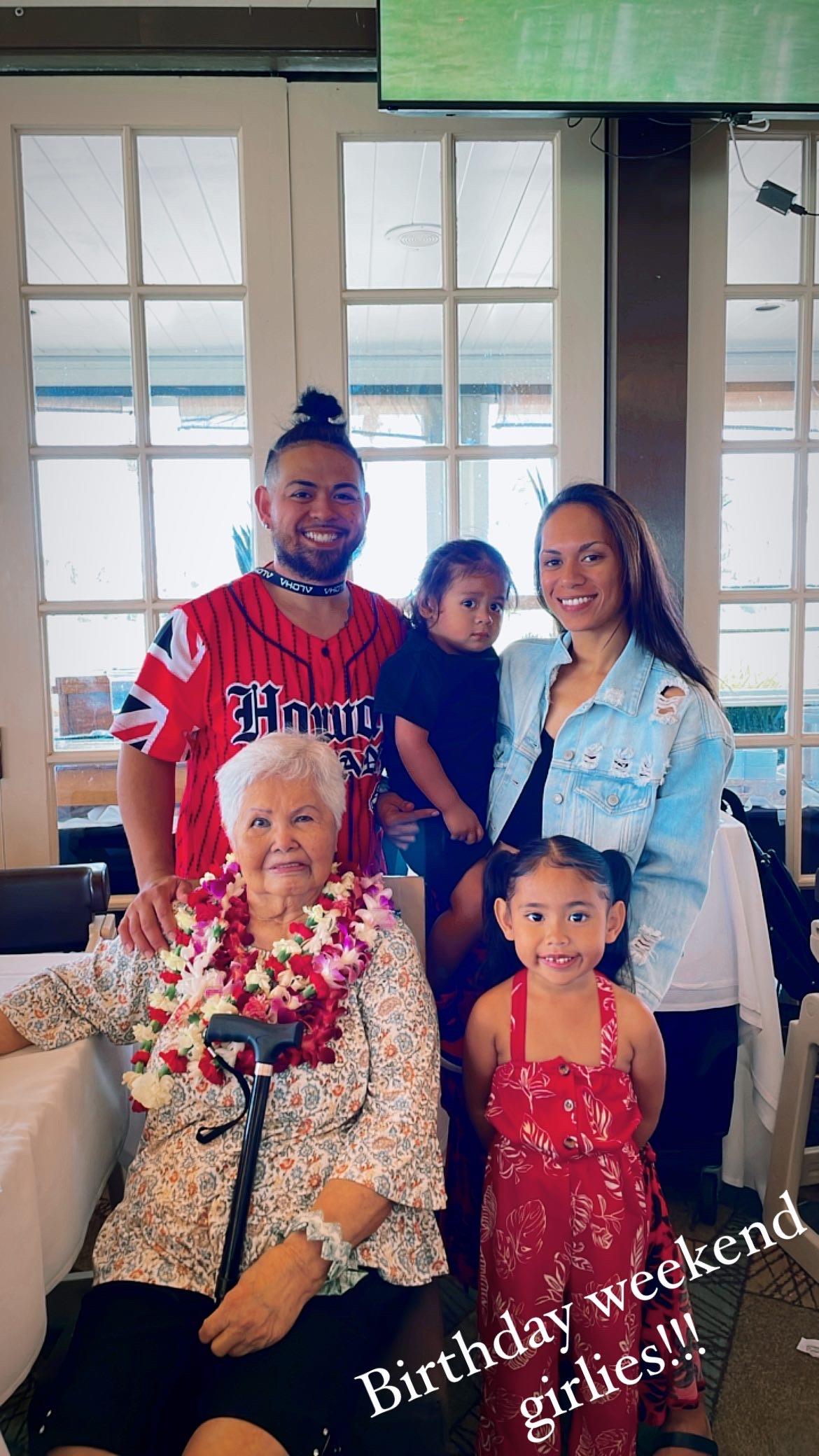 Family gathers together at a restaurant to celebrate a birthday with smiles and joy all around.