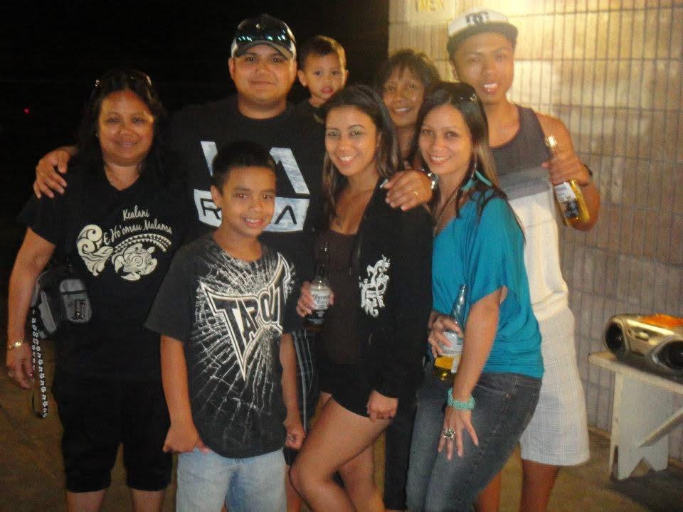 Friends and family gather joyfully during a nighttime celebration, sharing drinks and laughter.