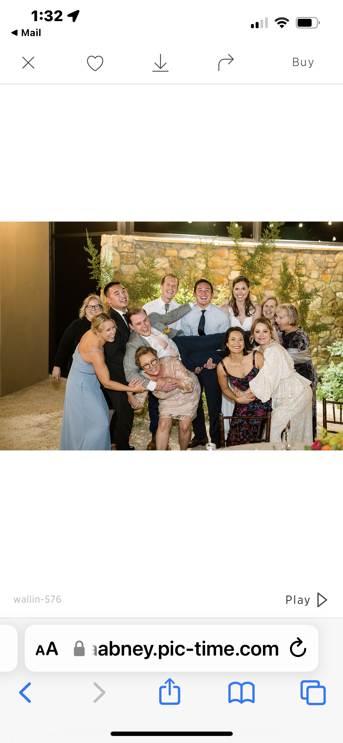 Group of friends joyfully celebrating together in a charming outdoor venue at night.