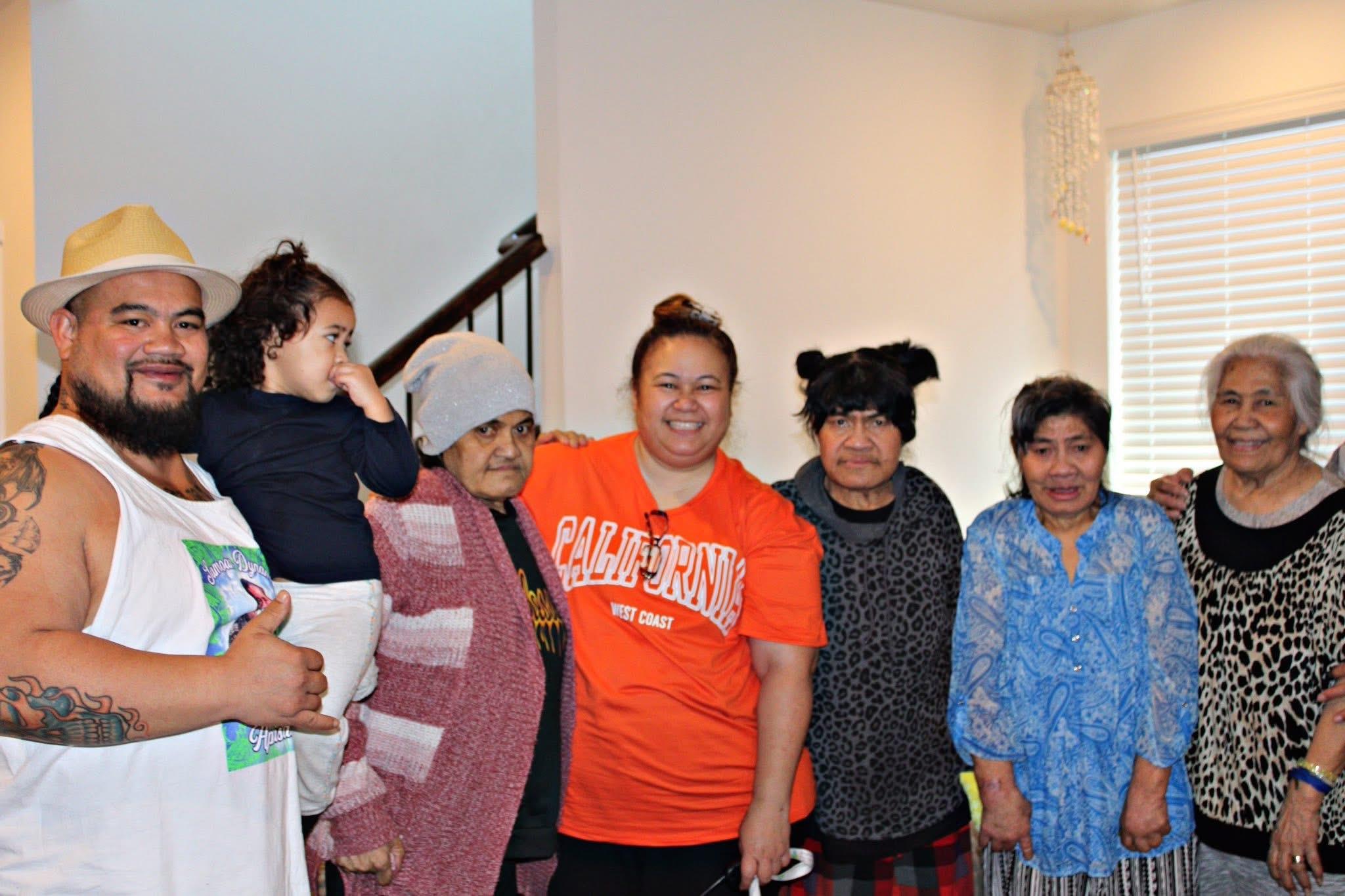 Family members gather indoors, engaging in joyful conversation and bonding in a warm atmosphere.