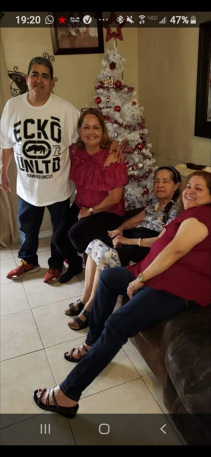 Family members celebrate the festive spirit together near the decorated Christmas tree.