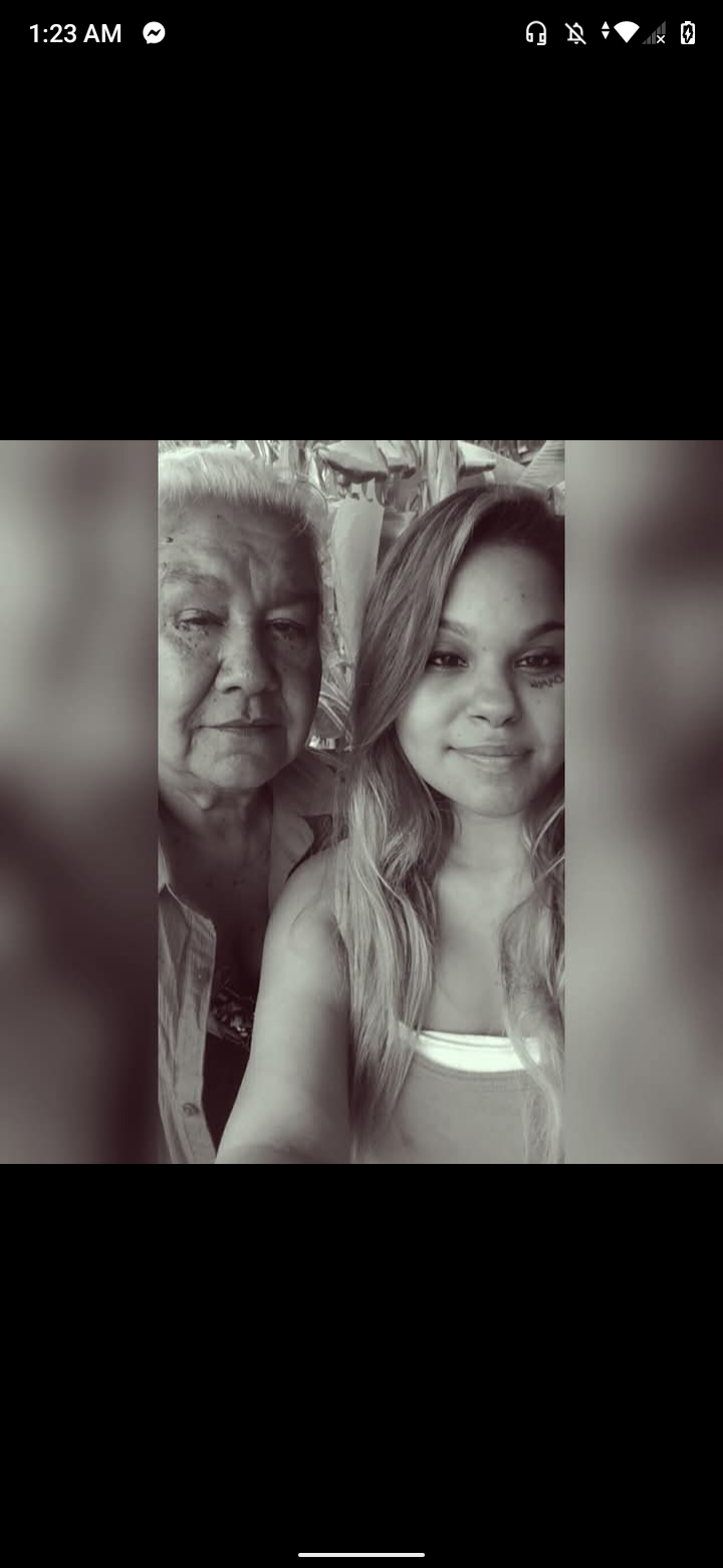 Two generations bond and smile warmly at a family event, sharing a special connection.