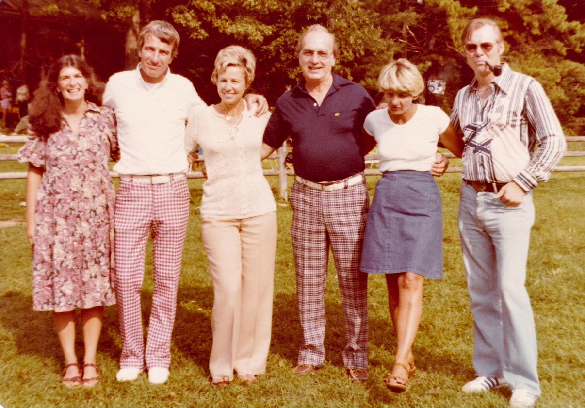 Friends gather on a sunny day, sharing laughter and smiles in a beautiful park setting.