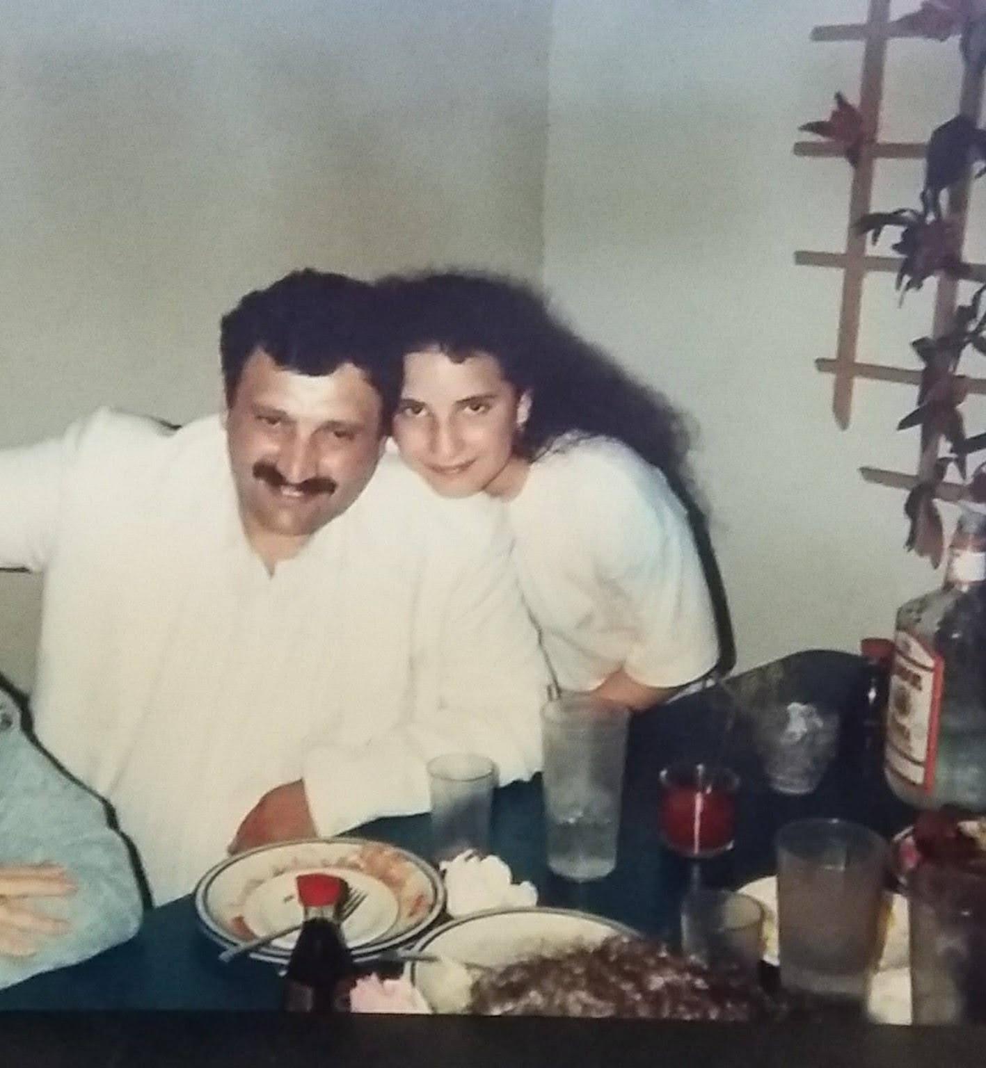 A man and a girl smile together, capturing a moment of happiness at a family gathering.
