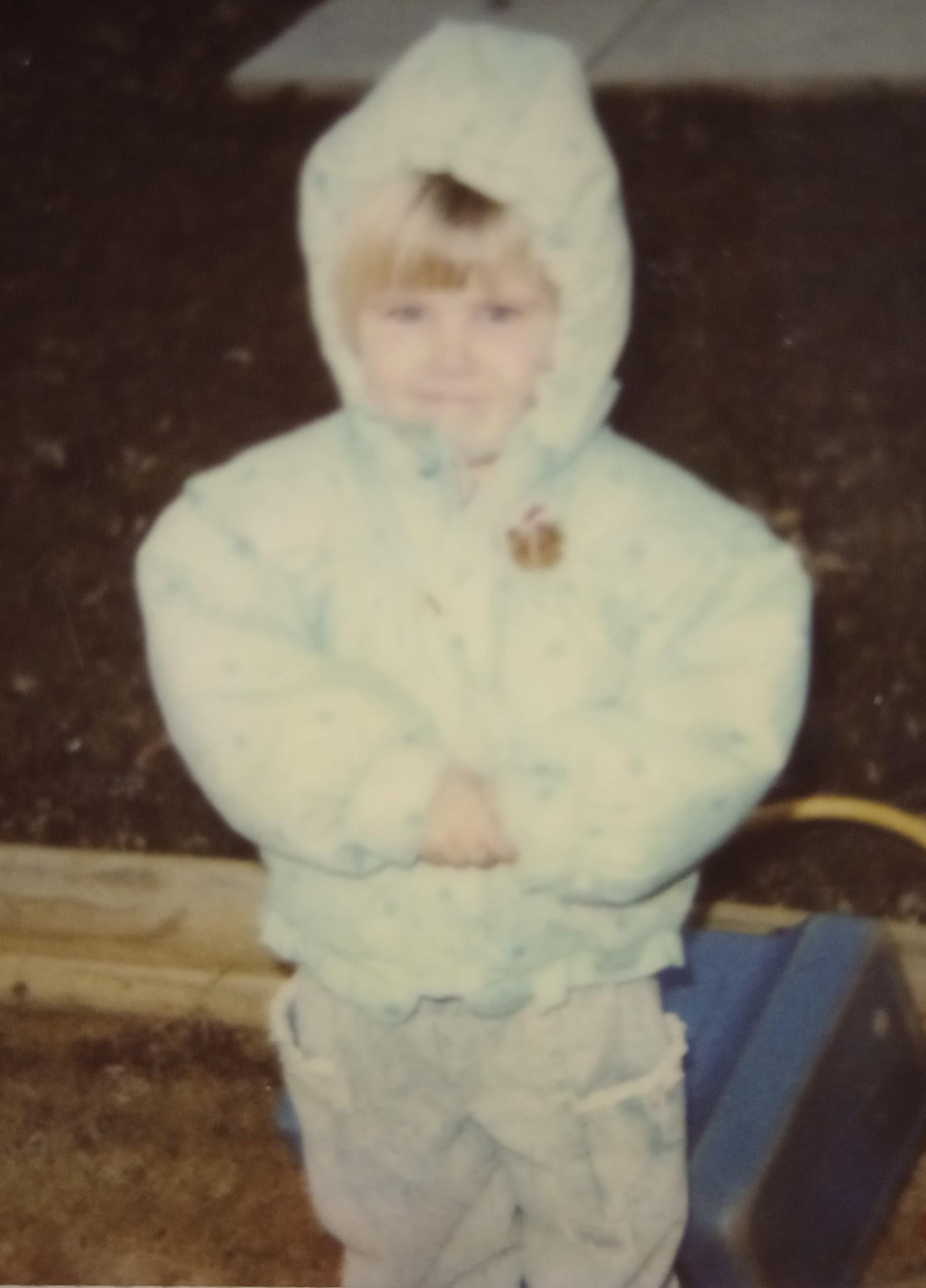 A child wearing a white coat