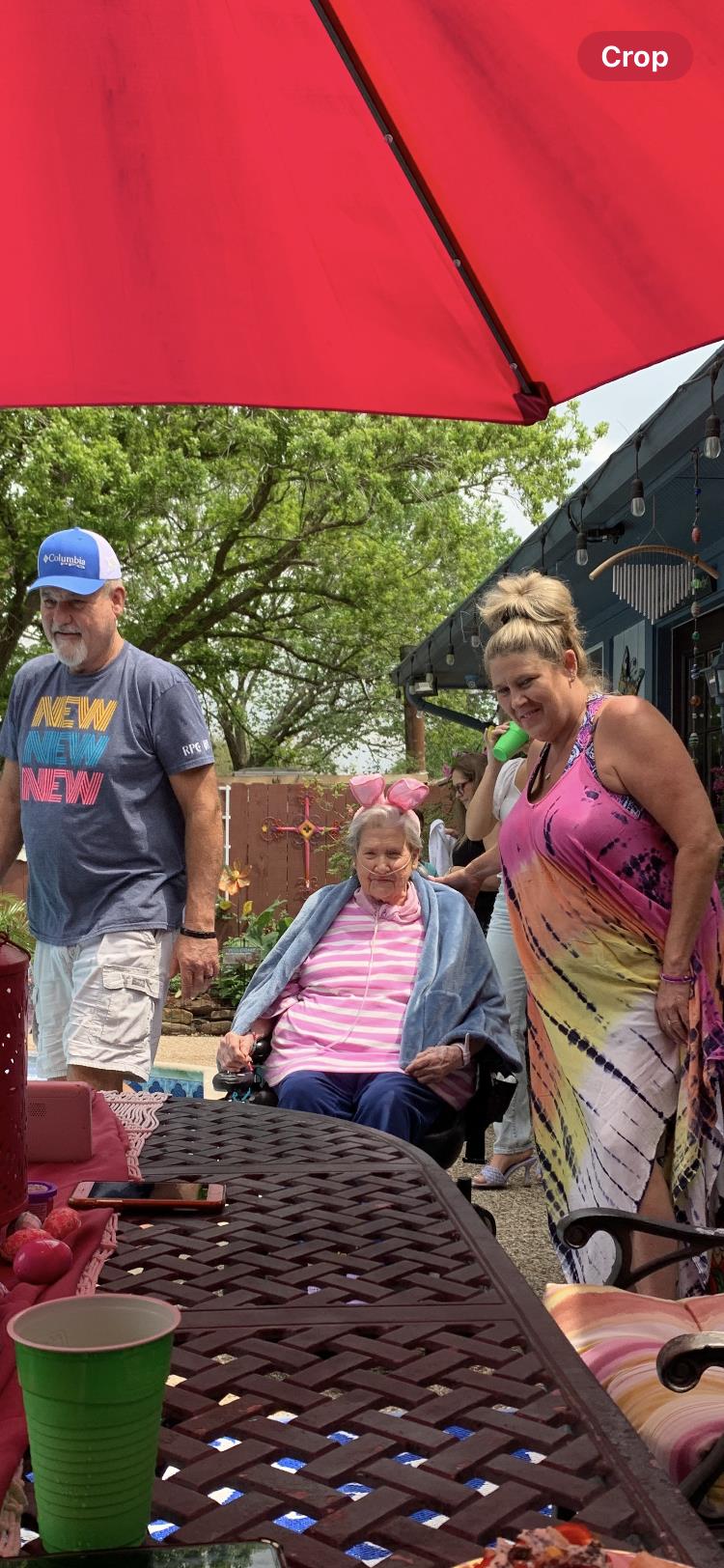 Family gathers in a backyard, enjoying each other's company and the warm weather together.