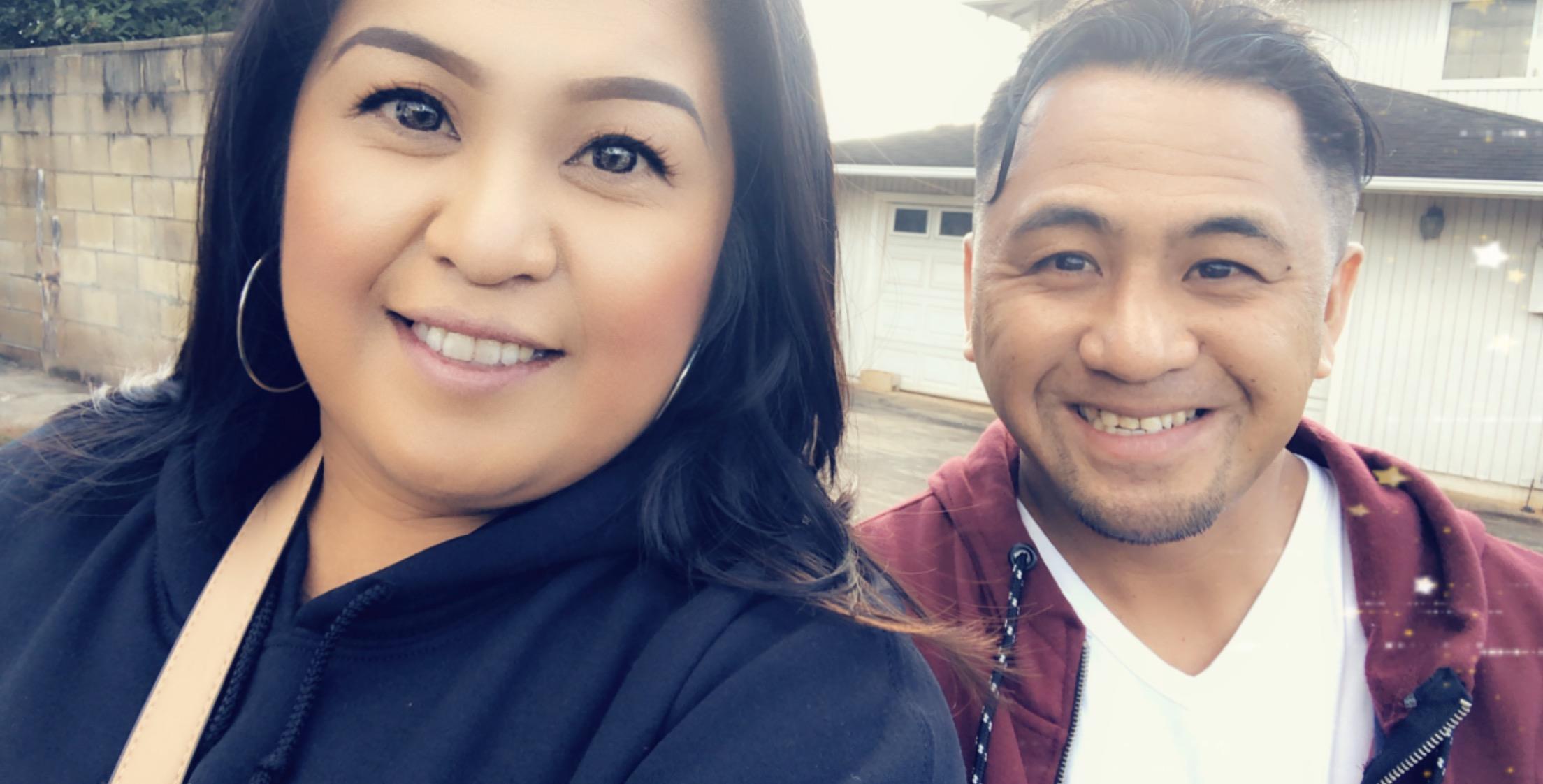 Two friends smile and enjoy each other's company while walking through their suburb.