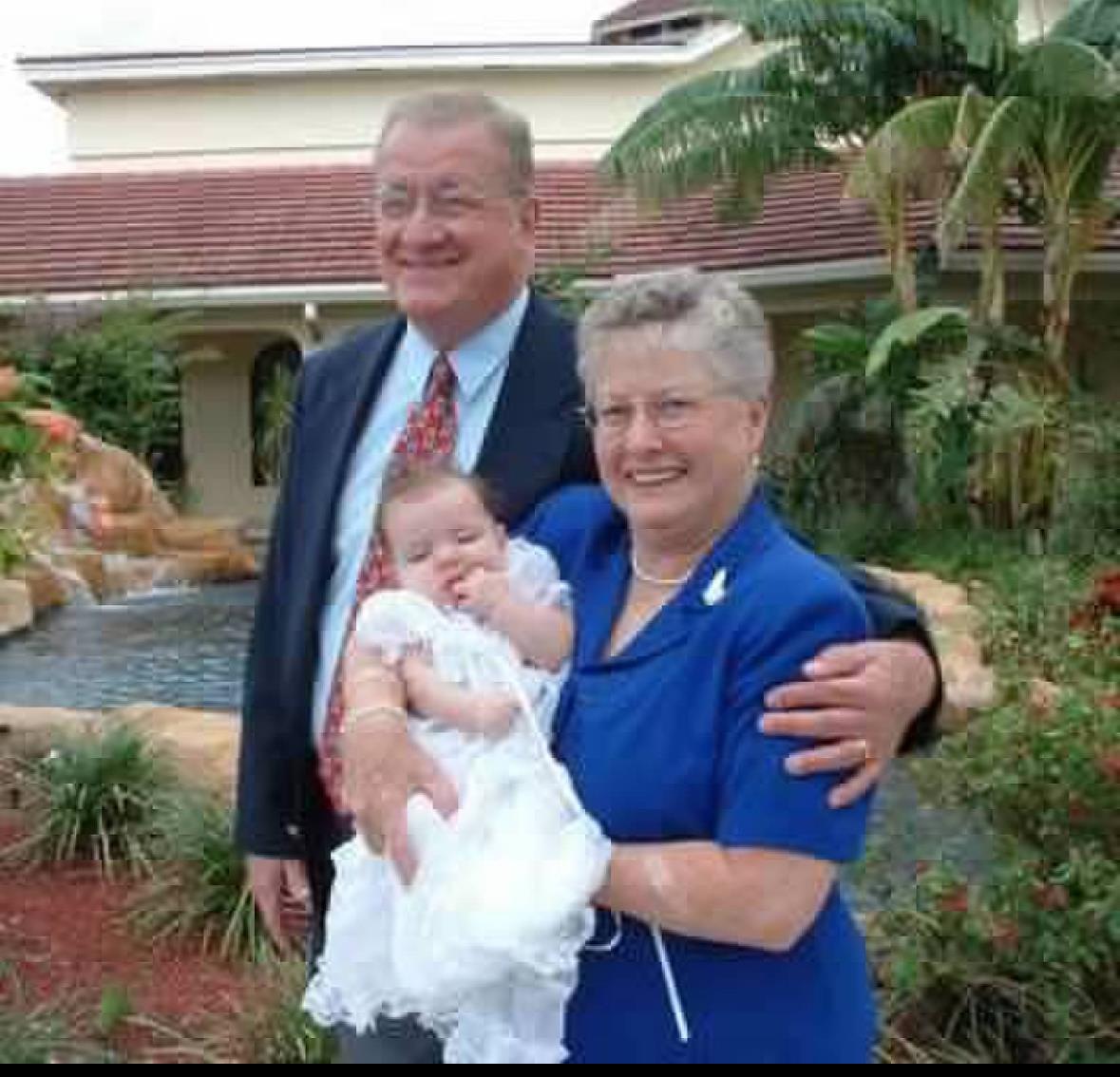 A joyful moment shared among family members in a lush garden while celebrating a special occasion.
