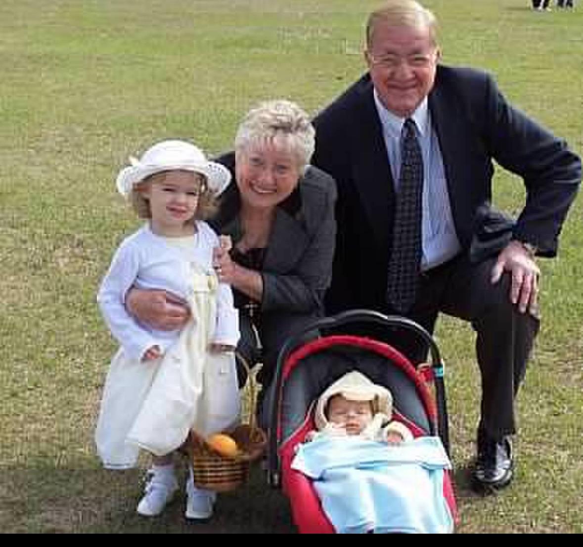 Grandparents have a joyful day with grandkids in a sunny, laughter-filled park.