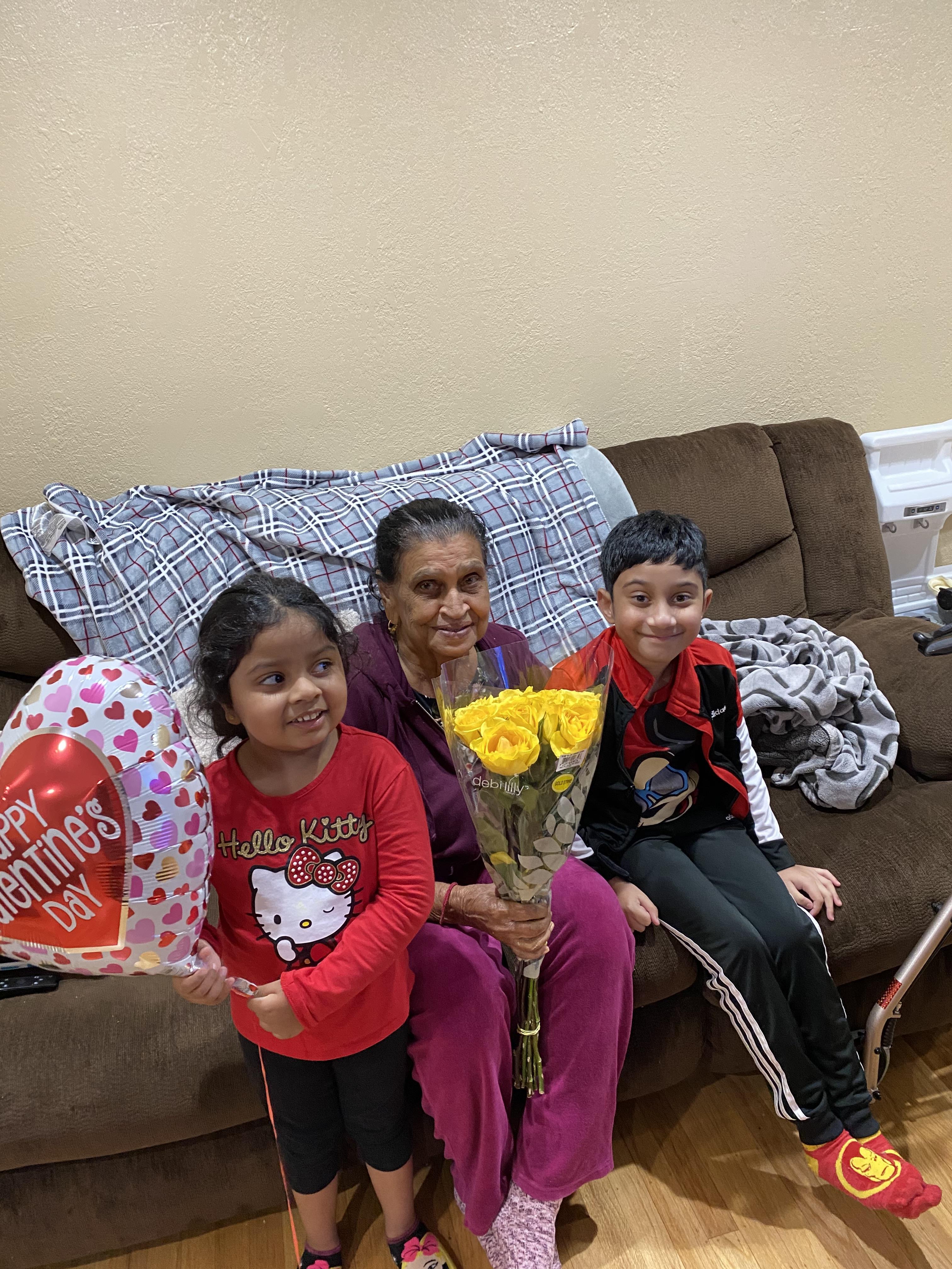 A woman and children sitting on a couch