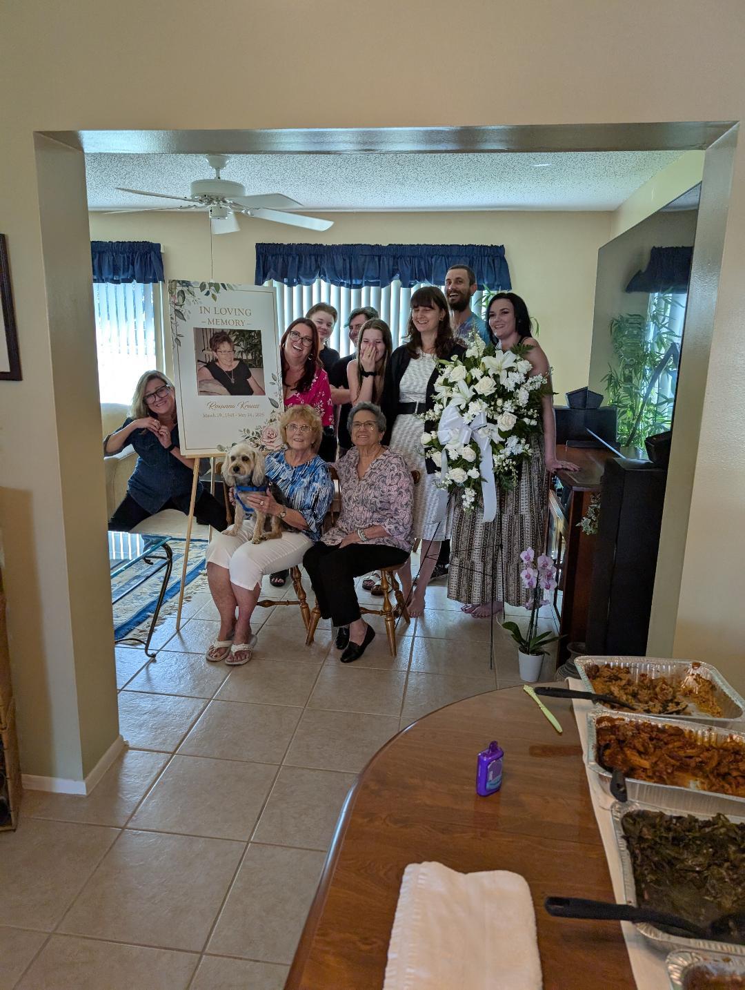 Friends and family gather in a warm home setting to celebrate and remember a dear loved one.