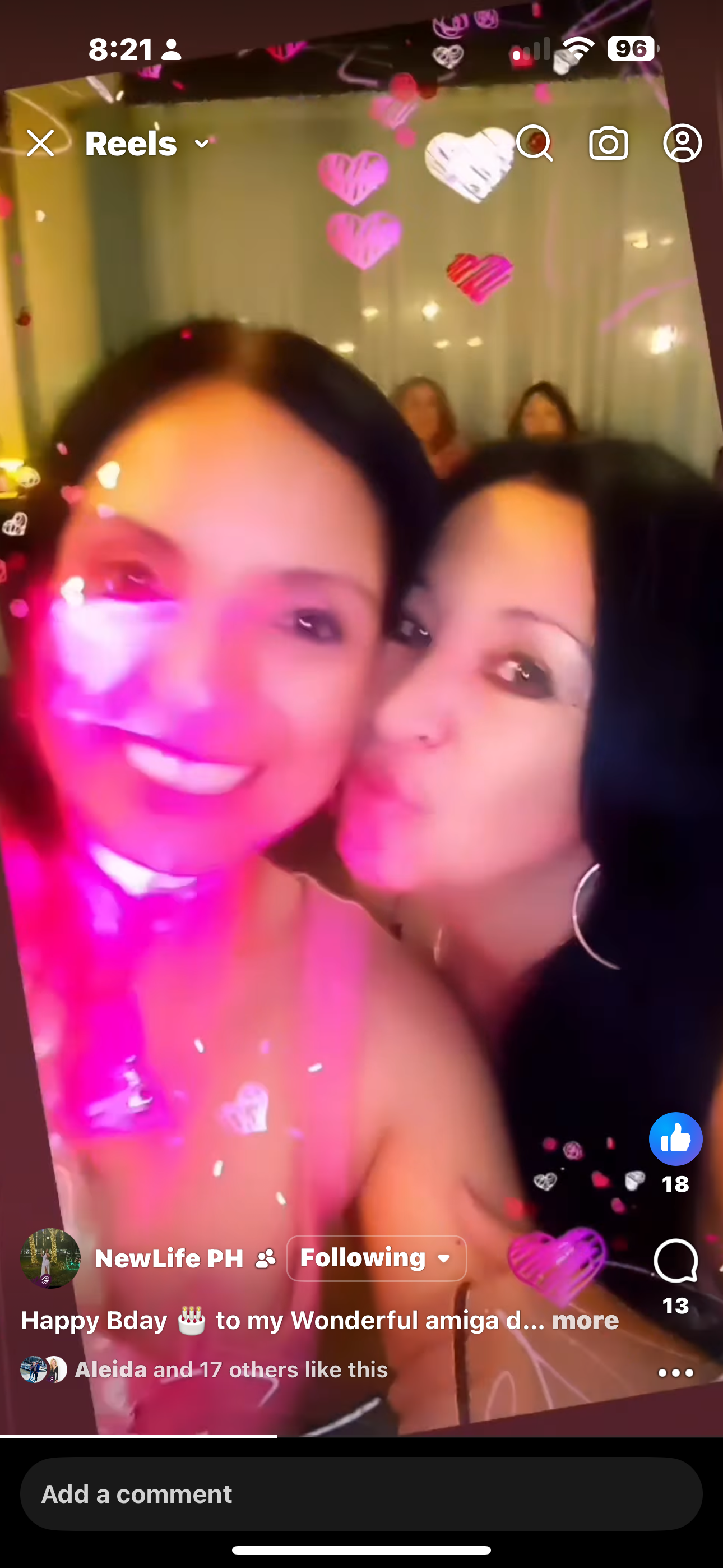 Two friends embrace, smiling and sharing joy during a birthday celebration.