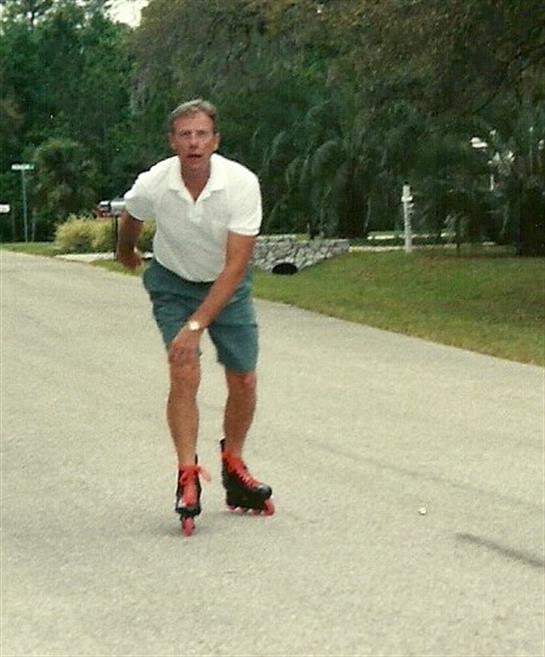 A man rollerblading on a road