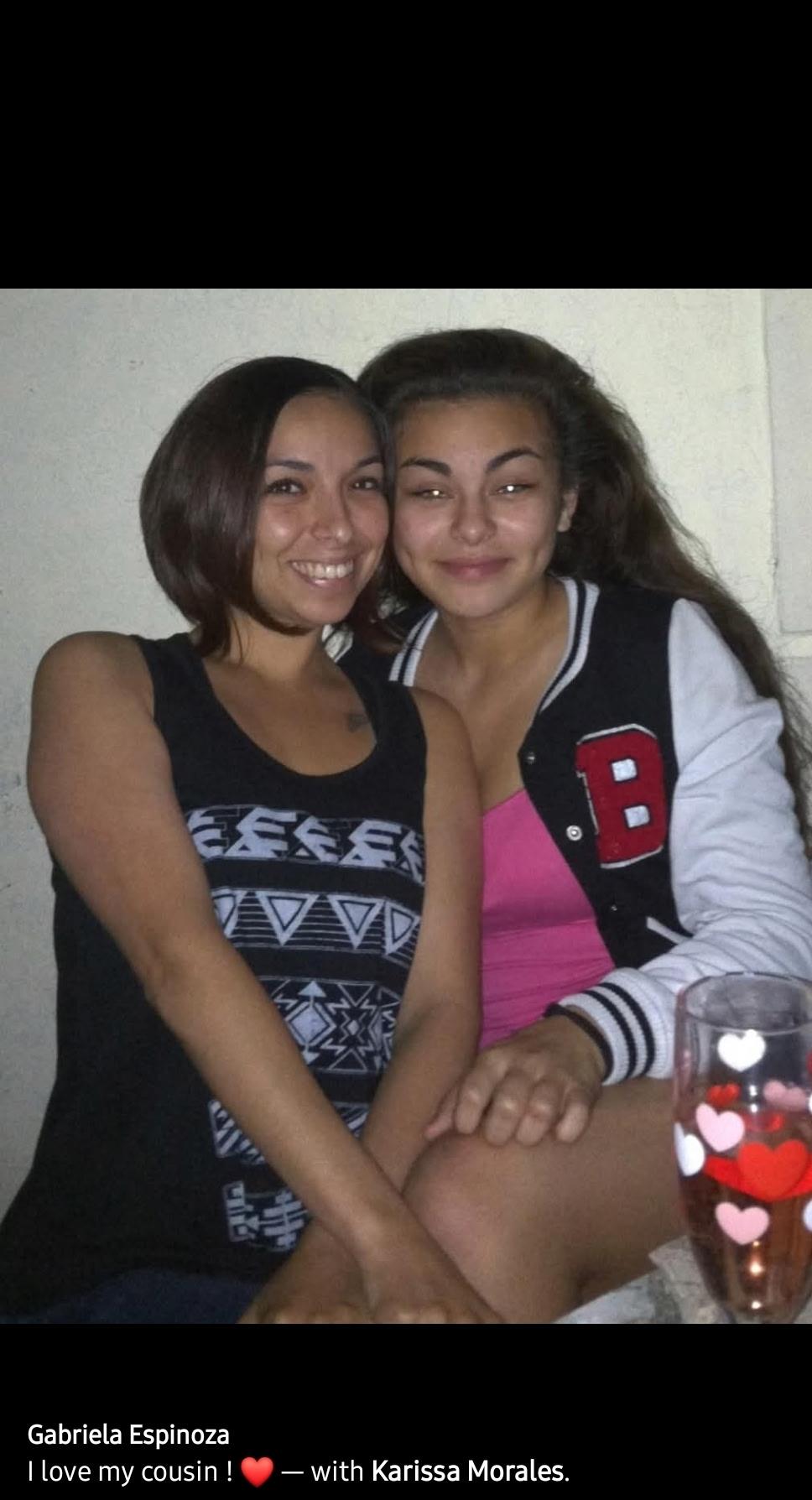 Two young women smile warmly while sitting close together, capturing a cherished family moment.